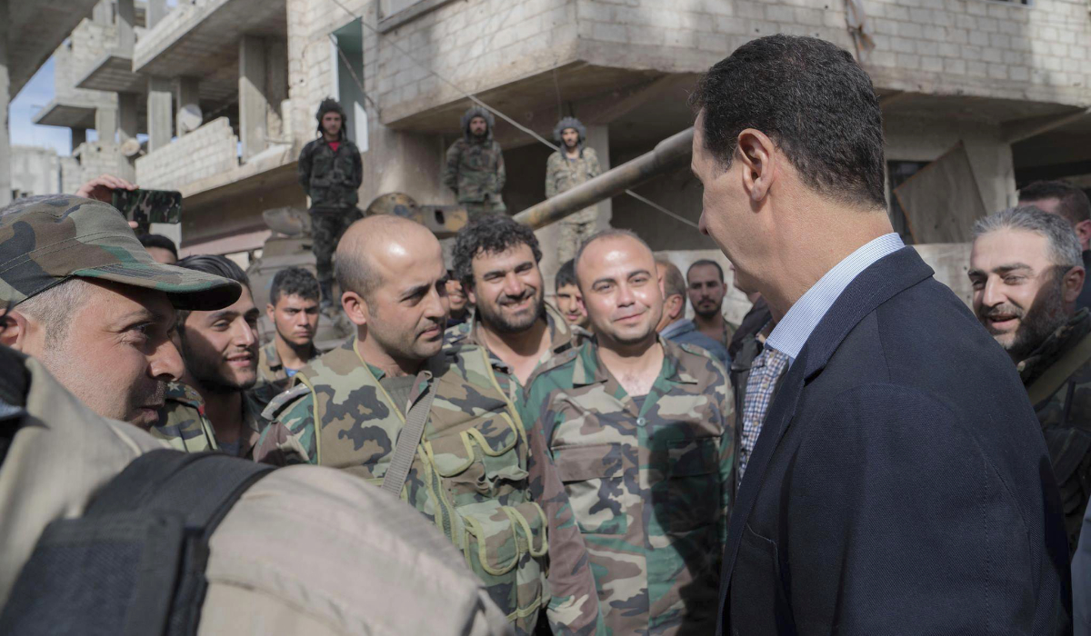 Syrian President Bashar Assad, right, speaks with Syrian troops during his visit to eastern Ghouta, near the capital Damascus, Syria. (AP file photo)