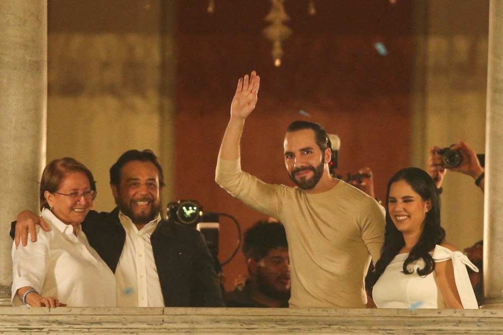 El Salvador's President, Nayib Bukele, who is running for reelection, greets supporters from the balcony of the National Palace next to his wife Gabriela de Bukele, Vice President Felix Ulloa and his wife Lilian Alvarenga de Ulloa, after declaring himself the winner in the presidential election in San Salvador, El Salvador, February 4, 2024. (Reuters)