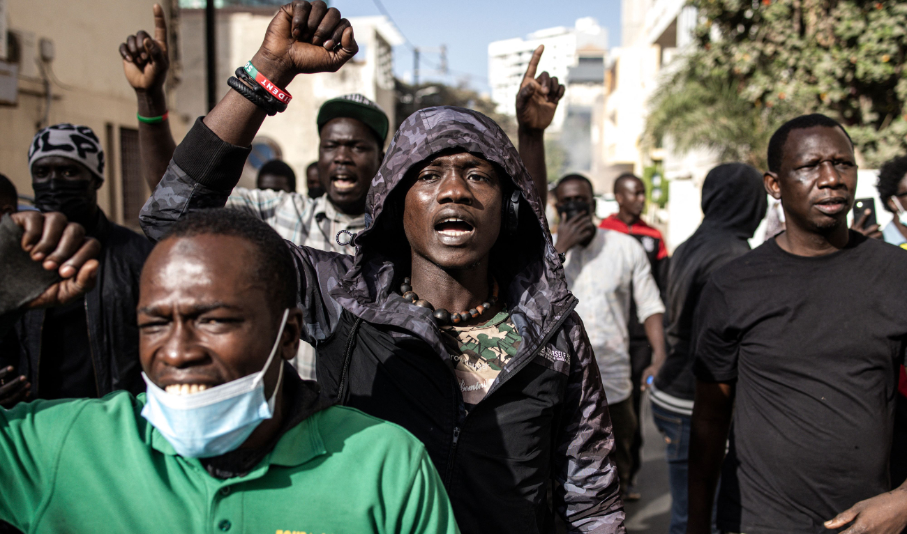 Protesters gesture after police fired teargas at them outside the General Assembly in Plateau, Dakar on February 5, 2024. (AFP)