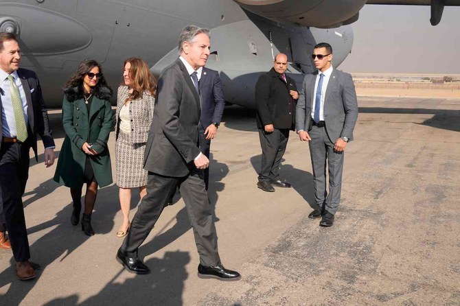 US Secretary of State Antony Blinken welcomed by the Second Secretary for Egypt's Ministry of Foreign Affairs protocol Sarah Henry (2L) and US Ambassador to Egypt Herro Mustafa Garg (3L), upon arrival at Cairo East Airport in Cairo. (AFP)