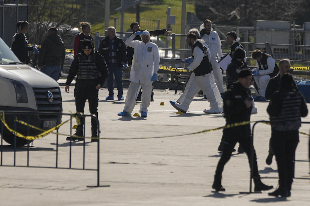 Security officers check the site where two attackers were killed outside a courthouse in Istanbul, Turkiye, Tuesday, Feb. 6, 2024. (AP)