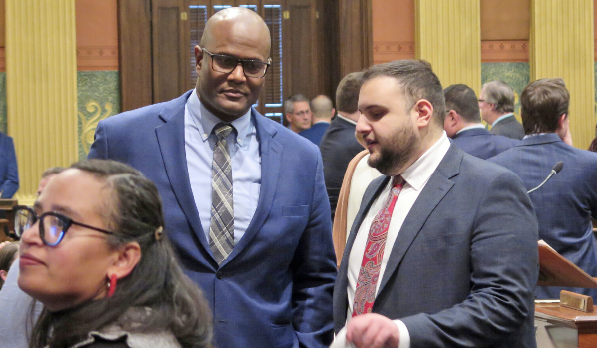 State Rep. Alabas Farhat, right, D-Dearborn, speaks with House Speaker Joe Tate on the Michigan House floor, Tuesday, Feb. 6, 2024, in Lansing, Mich. (AP)