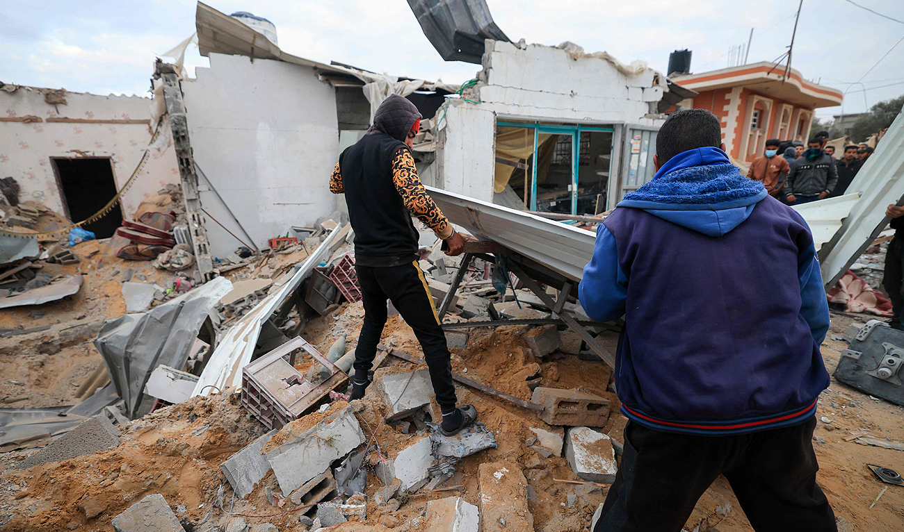 People look for survivors in the rubble of the Abu Saleh family home in Rafah in the southern Gaza Strip on February 5, 2024, after it was hit during Israeli bombardment, amid ongoing battles between Israel and the Palestinian Hamas group. (AFP)