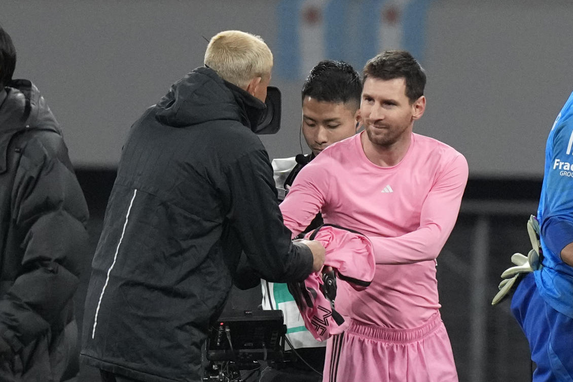 Inter Miami’s Lionel Messi gives his jersey to a Vissel Kobe’s official after their friendly match at the National Stadium, on Feb. 7, 2024, in Tokyo. (AP)