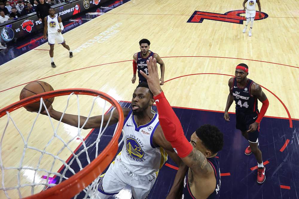 Andrew Wiggins of the Golden State Warriors shoots a layup past KJ Martin of the Philadelphia 76ers during their NBA game at the Wells Fargo Center on Feb. 07, 2024 in Philadelphia, Pennsylvania. (Getty Images North America/AFP)
