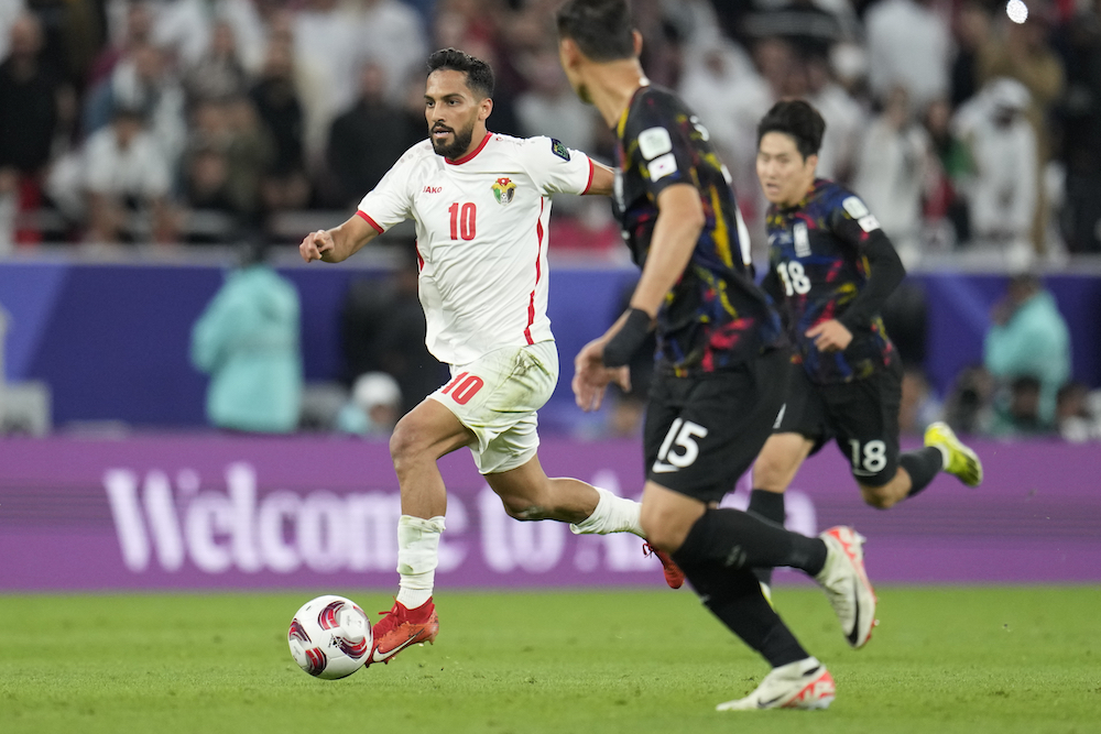 Mousa Al-Tamari, left, translated Jordan’s dominant tactical display into goals in front of a partisan crowd at the Ahmad Bin Ali Stadium in Al-Rayyan, Qatar on Feb. 6, 2024. (AP)