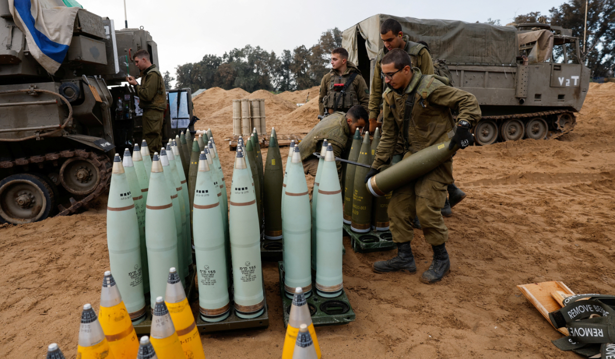 Israeli soldiers prepare shells near a mobile artillery unit, amid the ongoing conflict between Israel and the Palestinian group Hamas, in Israel, January 2, 2024. (REUTERS)