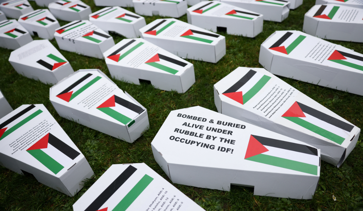 Mock coffins with Palestinian flags lay on the grass as demonstrators gather for a vigil for Gaza, amid the ongoing conflict between Israel and the Palestinian Islamist group Hamas, in London, Britain February 10, 2024. (REUTERS)