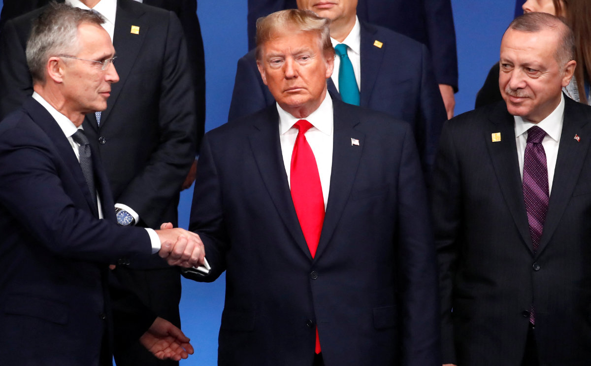 In this photo taken on December 4, 2019, the US President Donald Trump (C) shakes hands with NATO Secretary General Jens Stoltenberg, next to Turkish President Recep Tayyip Erdogan during a family photo as part of the NATO summit in Watford, northeast of London. (Pool/AFP/File)