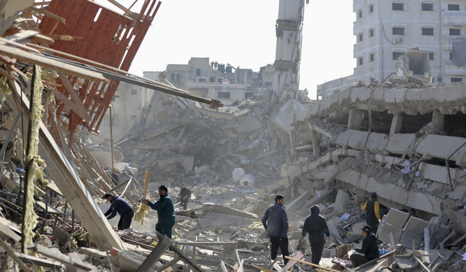 Palestinians walk through the destruction left by the Israeli air and ground offensive on the Gaza Strip in Gaza City, Saturday, Feb. 10, 2024. (AP)
