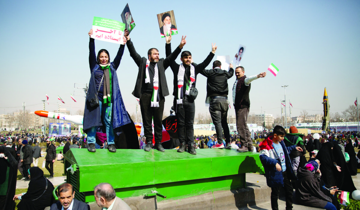Crowds in Tehran’s Azadi Square hold up portraits of the supreme leader, Ayatollah Ali Khamenei, as well as of the founder of the Islamic republic, Ayatollah Ruhollah Khomeini, at Sunday’s rally. (Reuters)