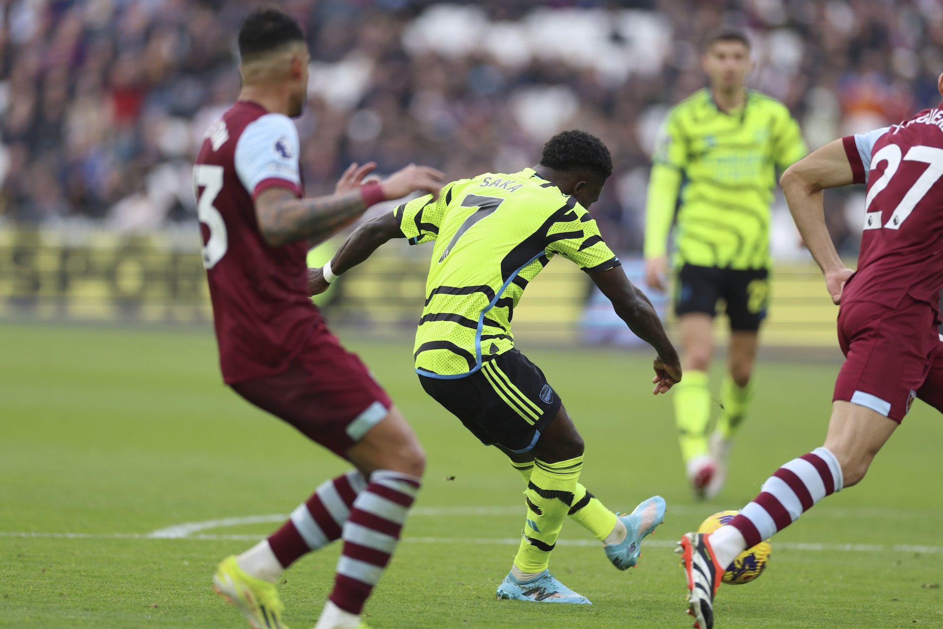 Arsenal's Bukayo Saka shoots and scores his side's 5th goal of the game during the English Premier League soccer match between West Ham United and Arsenal at the London Stadium in London Sunday. (AP)