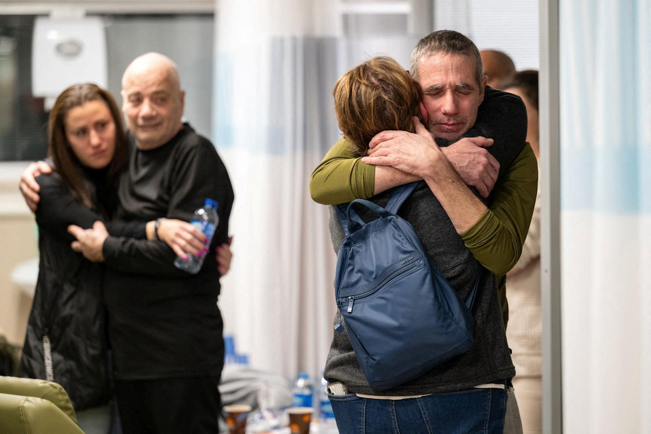 Fernando Simon Marman and Louis Hare reunite with loved ones at the Sheba Medical Center, in Ramat Gan, Israel, February 12, 2024. (Reuters)