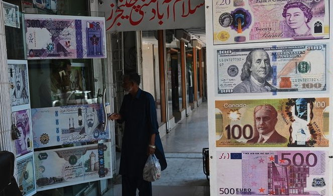 A man enters a foreign currency exchange shop in Islamabad on July 11, 2023. (AFP/File)
