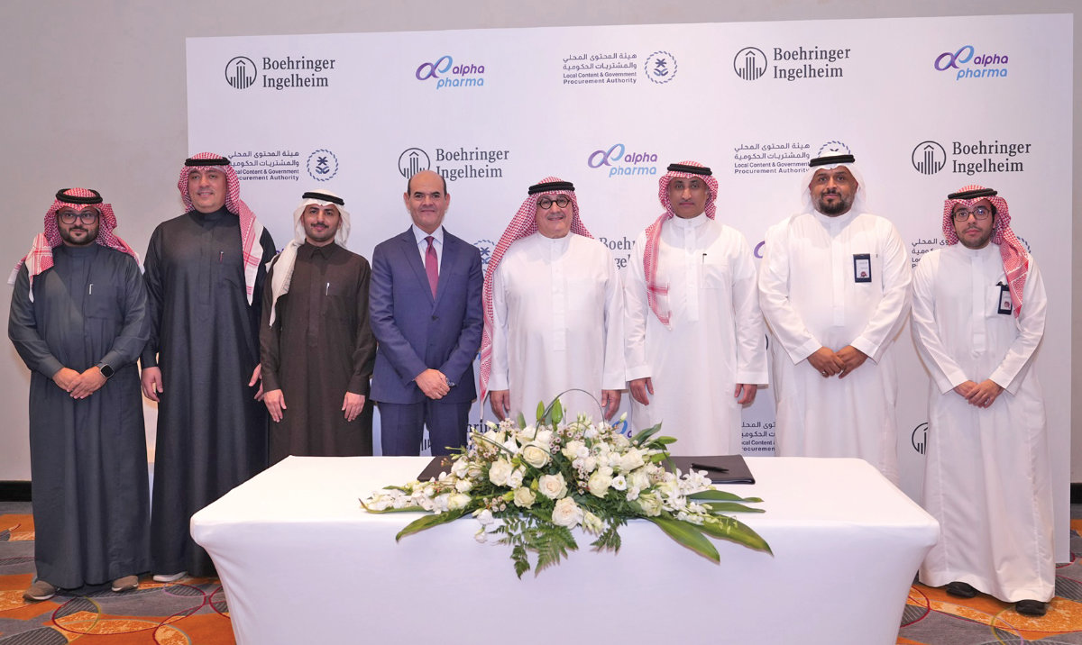 Waleed Mashak, general manager at Boehringer Ingelheim, and Sheikh Yaser Al-Naghi, chairman of Alpha Pharma, with other officials at the signing ceremony in Jeddah.