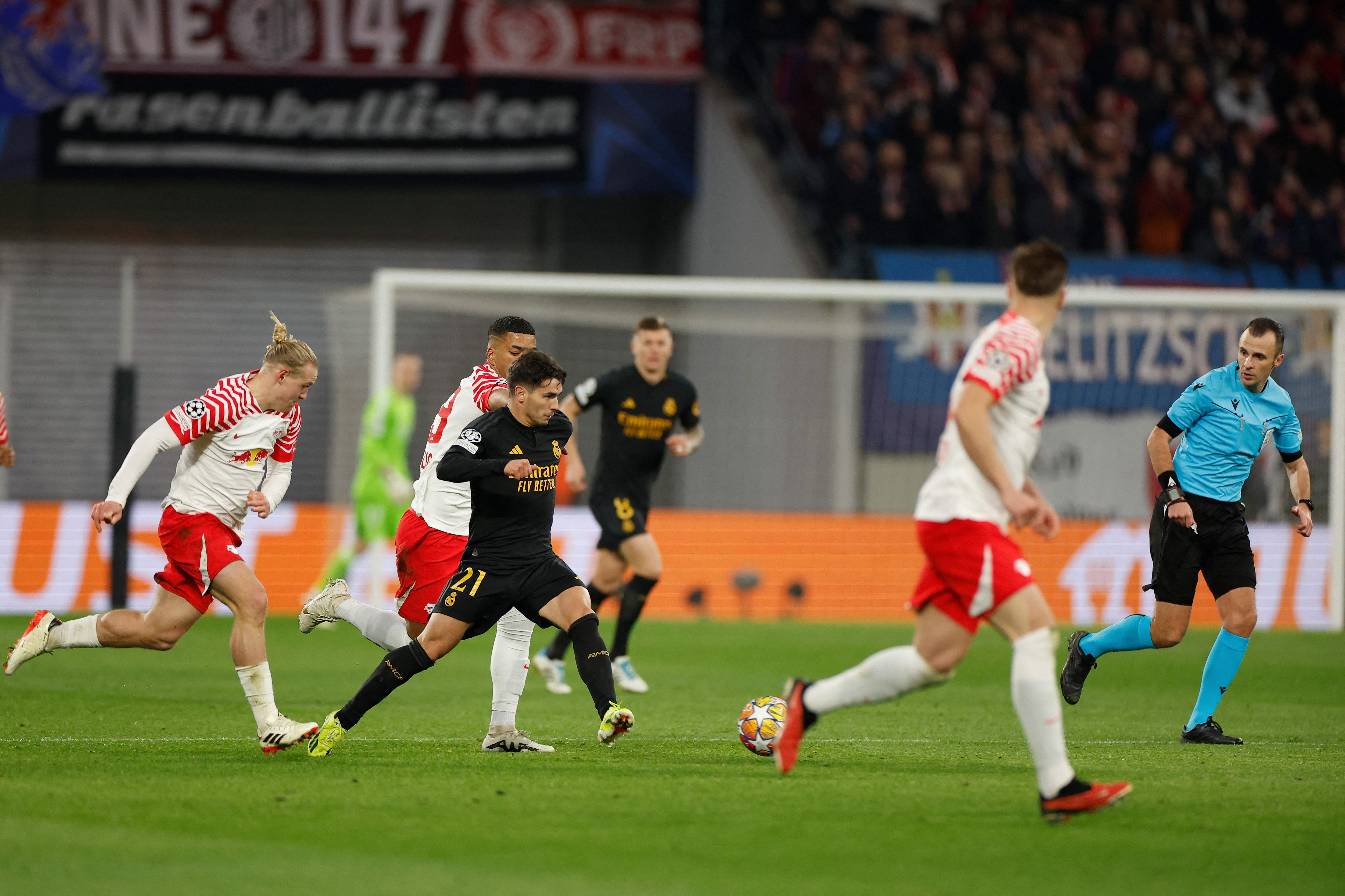 Real Madrid's Spanish forward #21 Brahim Diaz (C) gets away from the Leipzig duo of Austrian midfielder #24 Xaver Schlager (L) and German defender #39 Benjamin Henrichs during their UEFA Champions League round of 16 first-leg match in Leipzig on Feb. 13, 2024. (AFP)