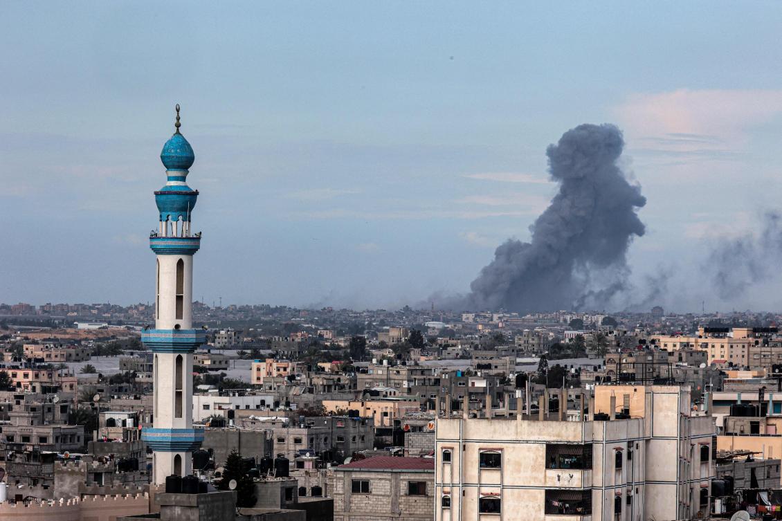 This picture taken from Rafah shows smoke billowing over Khan Yunis in the distance following Israeli bombardment on the southern Gaza Strip on Feb. 14, 2024. (AFP)