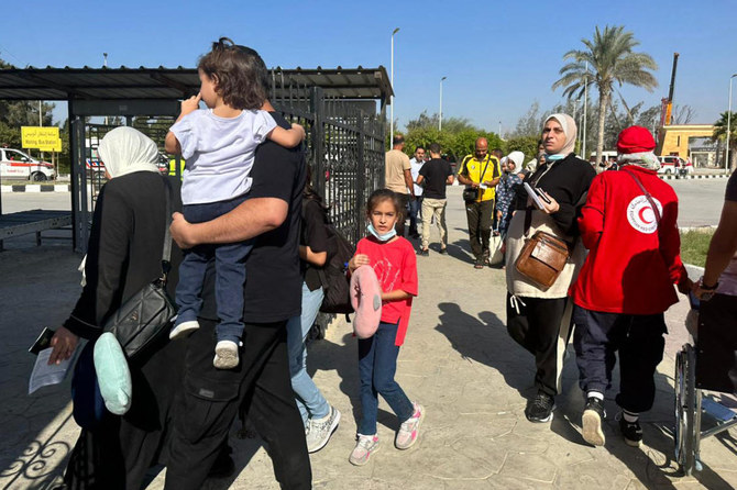 People cross into Egypt’s Rafah border crossing with the Gaza Strip on Nov. 9, 2023. (File/AFP)