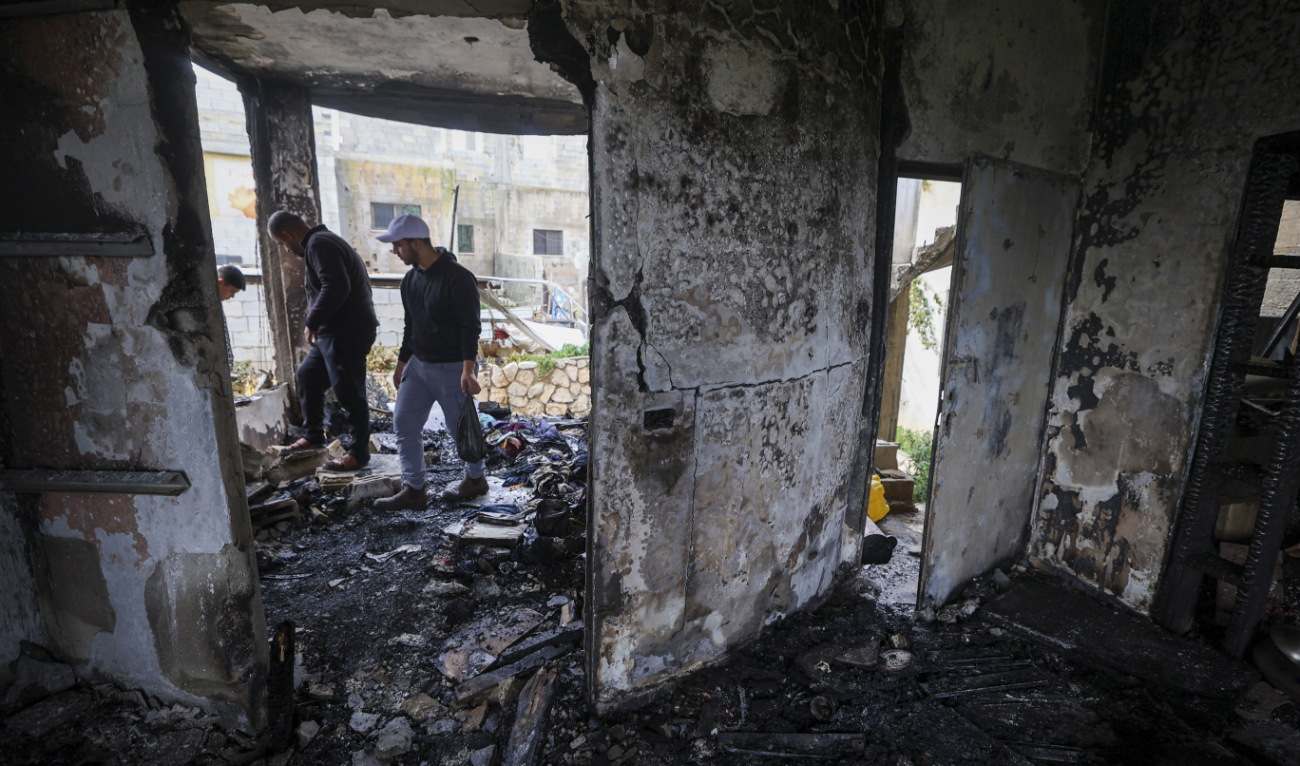 Palestinians stand inside a house damaged during a raid by Israeli security forces in the village of Sir, south of Jenin, in the occupied West Bank on February 13, 2024. (AFP/File)