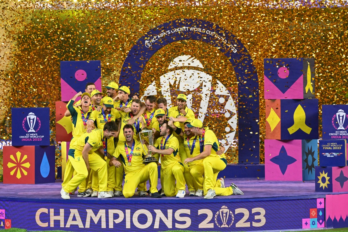 Australia's players celebrate with the trophy after winning the 2023 ICC Men's Cricket World Cup one-day international (ODI) final match against India at the Narendra Modi Stadium in Ahmedabad on November 19, 2023.(AFP)