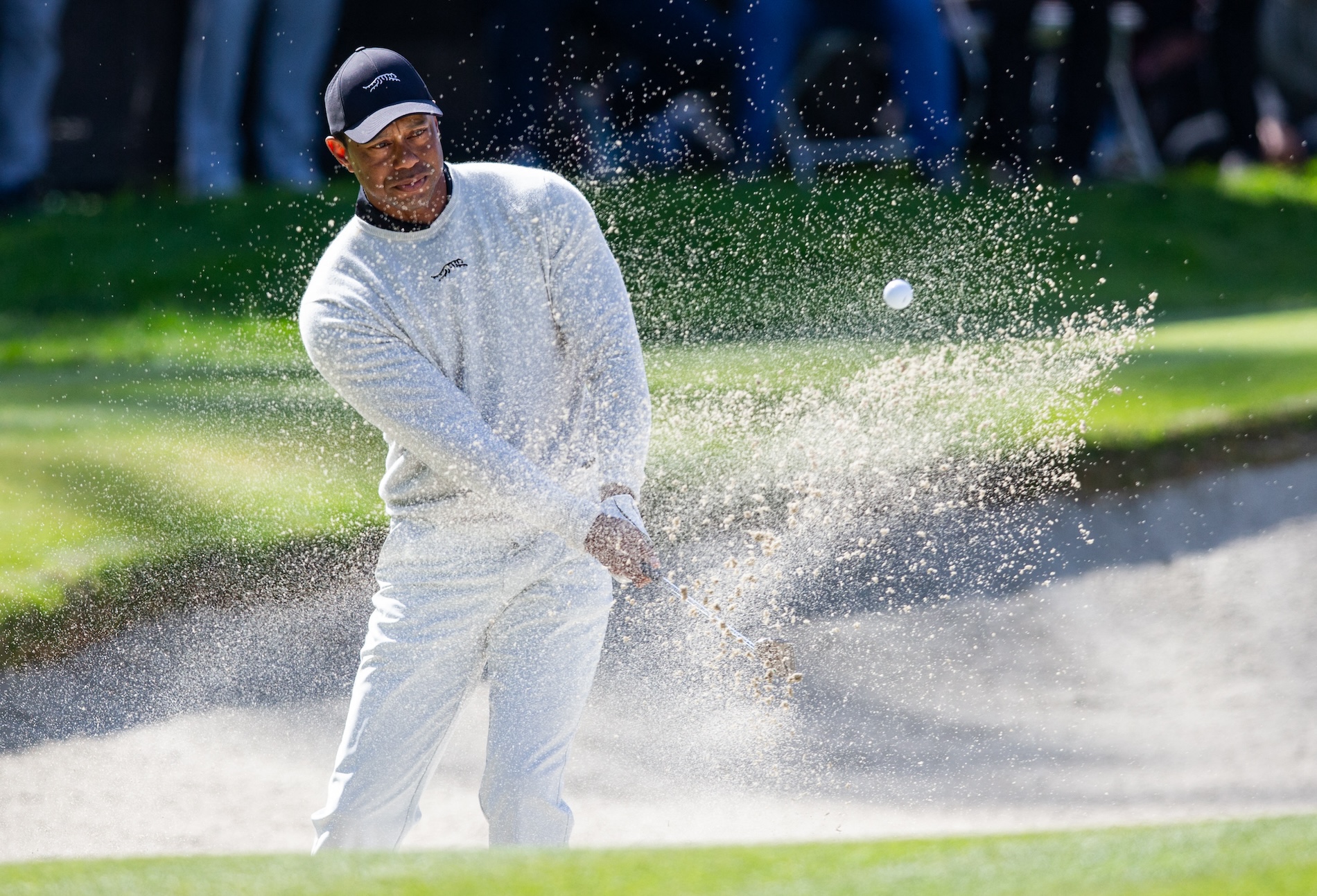 Tiger Woods hits from the sand on the 10th hole during the first round of The Genesis Invitational golf tournament on Thursday. (USA TODAY Sports)