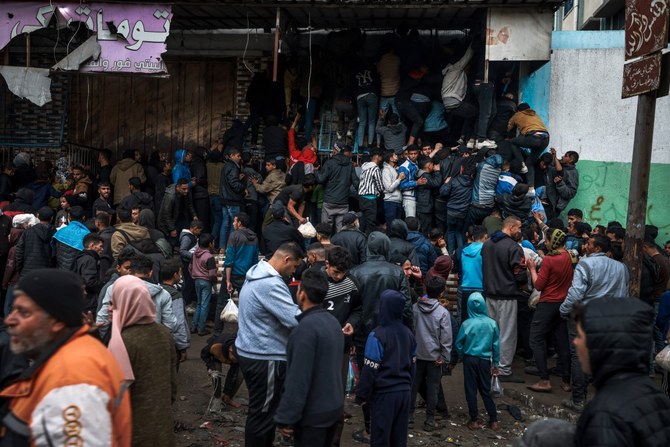 Palestinians crowd oustide a bakery to buy bread in Rafah on the southern Gaza Strip. (AFP)