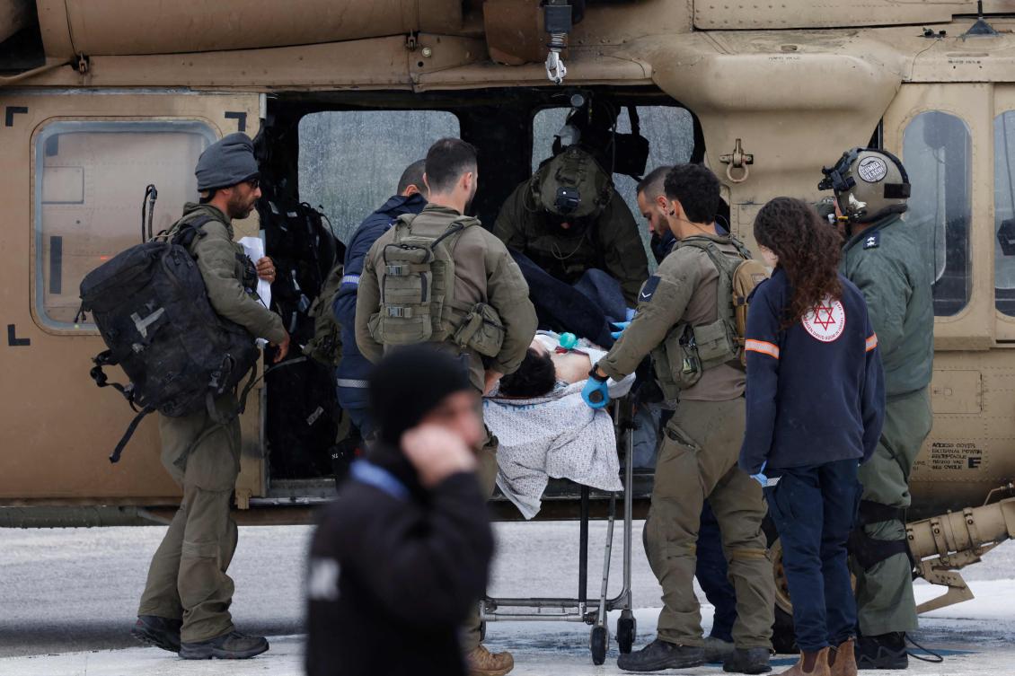 An Israeli medical team transports a peson wounded in a rocket attack fired from southern Lebanon at Ziv hospital in Israel’s northern city of Safed on Feb. 14, 2024, amid ongoing cross-border tensions. (AFP)
