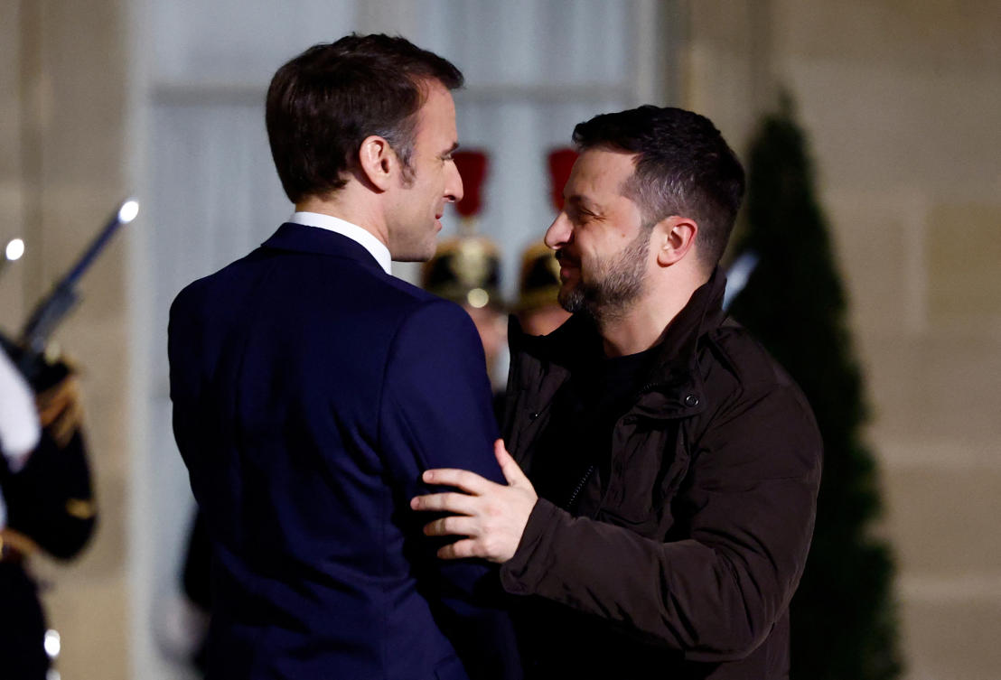 French President Emmanuel Macron hugs Ukrainian President Volodymyr Zelensky as he arrives for a meeting to sign a bilateral security deal, at the Elysee Palace in Paris on Feb. 16, 2024. (Reuters)