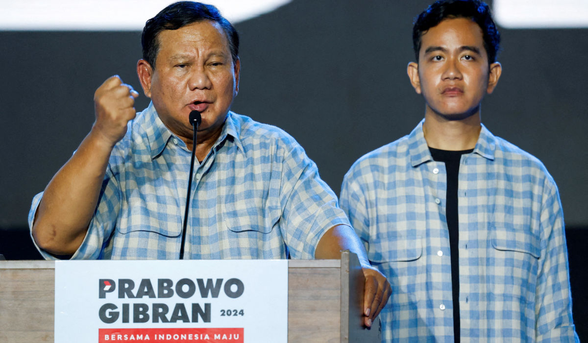 Indonesia's Defence Minister and leading Presidential candidate Prabowo Subianto delivers his speech as his running mate Gibran Rakabuming Raka, the eldest son of Indonesian President Joko Widodo and current Surakarta's Mayor, stands, as they claim victory after unofficial vote counts during an event to watch the results of the general election in Jakarta, Indonesia, February 14, 2024. (REUTERS)