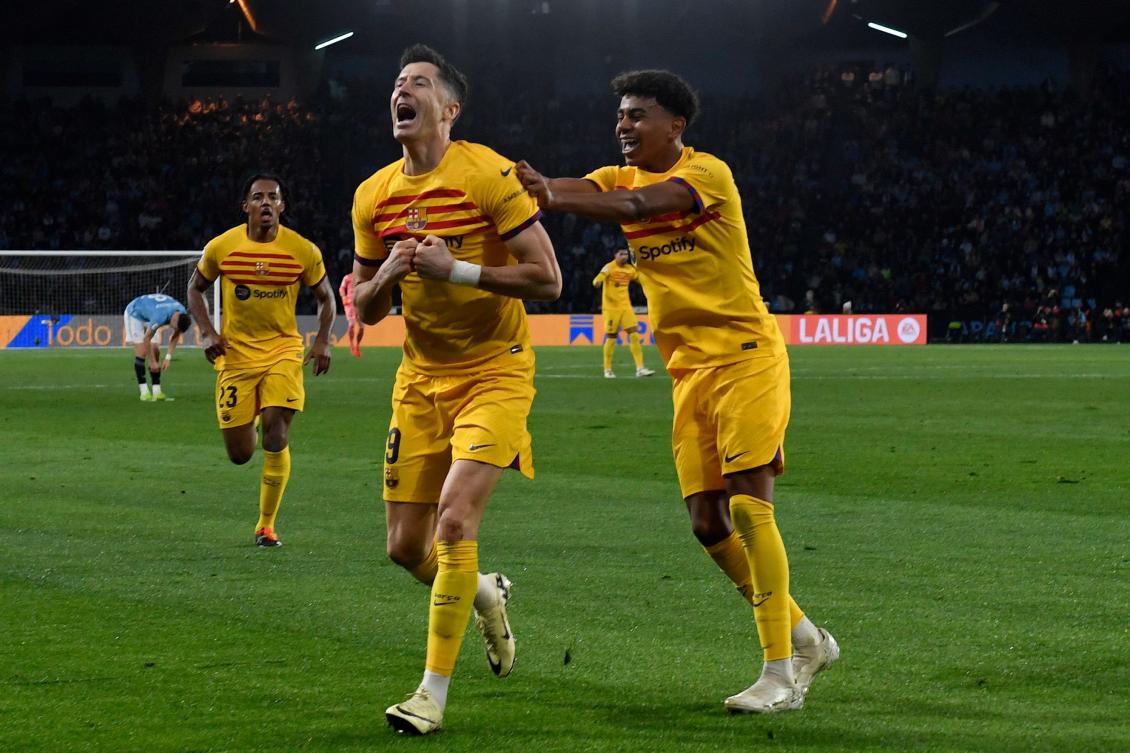 Barcelona’s Polish forward Robert Lewandowski celebrates with Lamine Yamal after scoring his team’s first goal during their Spanish league match against RC Celta de Vigo at the Balaidos stadium in Vigo on Feb. 17, 2024. (AFP)