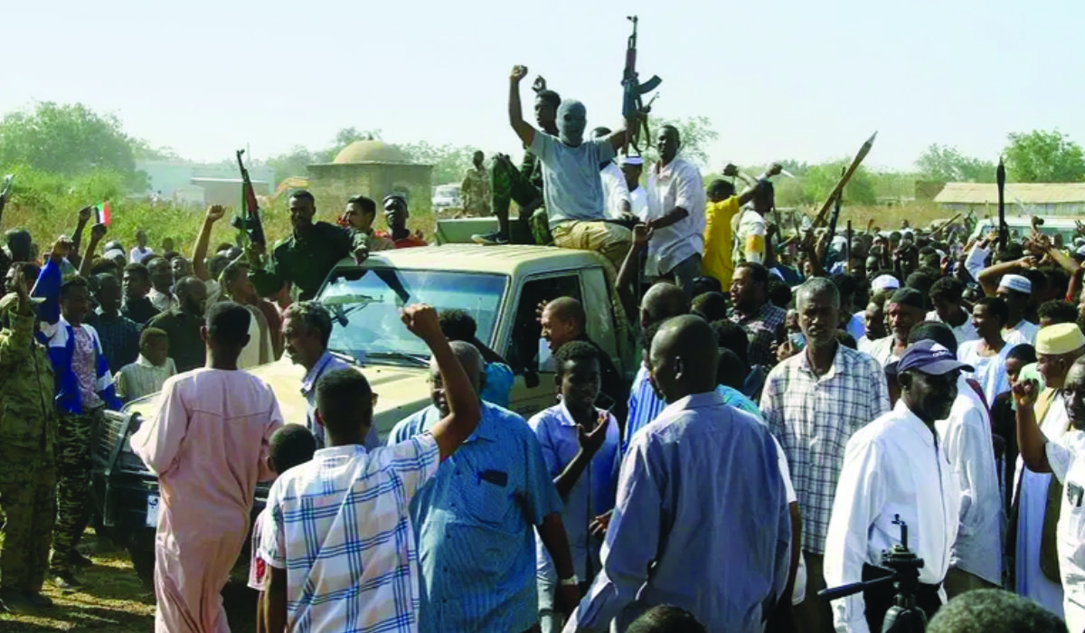 Supporters of the Sudanese popular resistance, which backs the army, raise their weapons in Gedaref town on Jan. 16. (AFP)