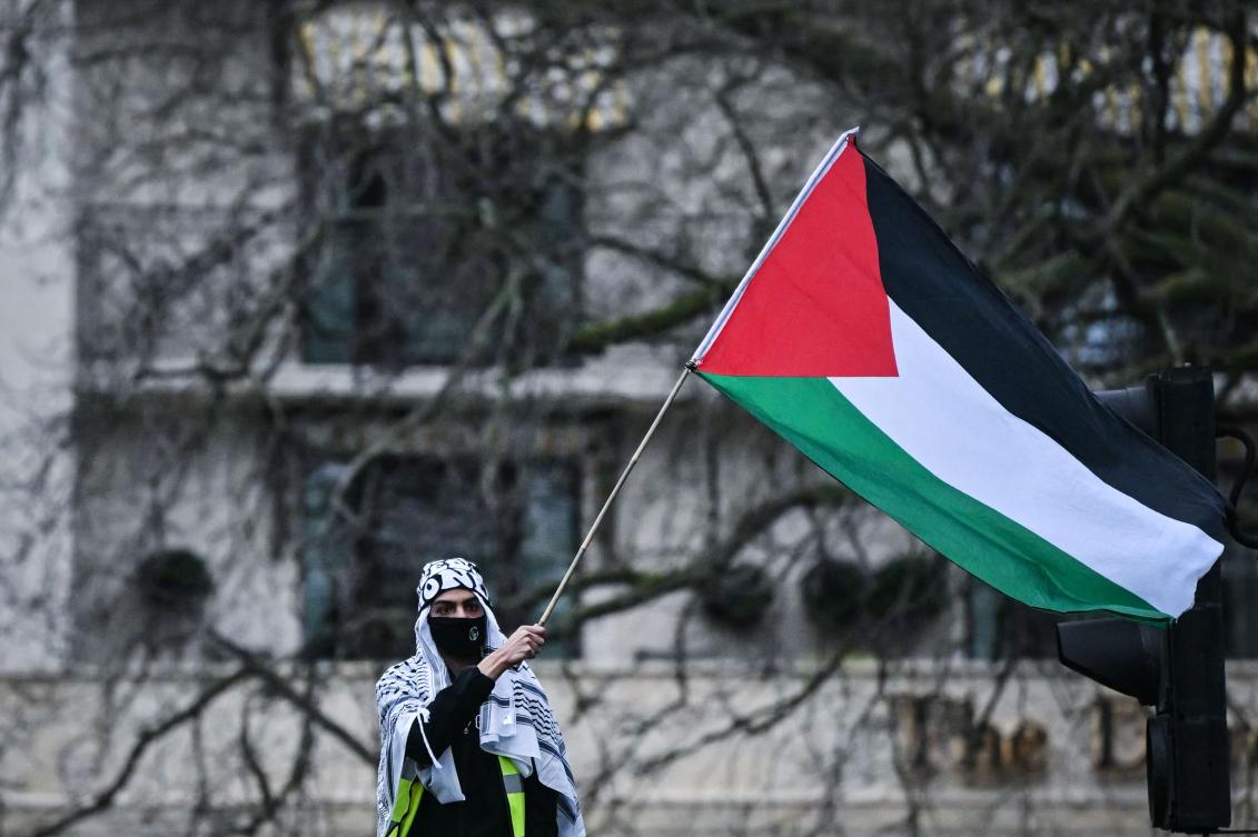 A Pro-Palestinian supporter waves a Palestinian flag during a National March for Palestine in central London on Feb. 17, 2024. (AFP)