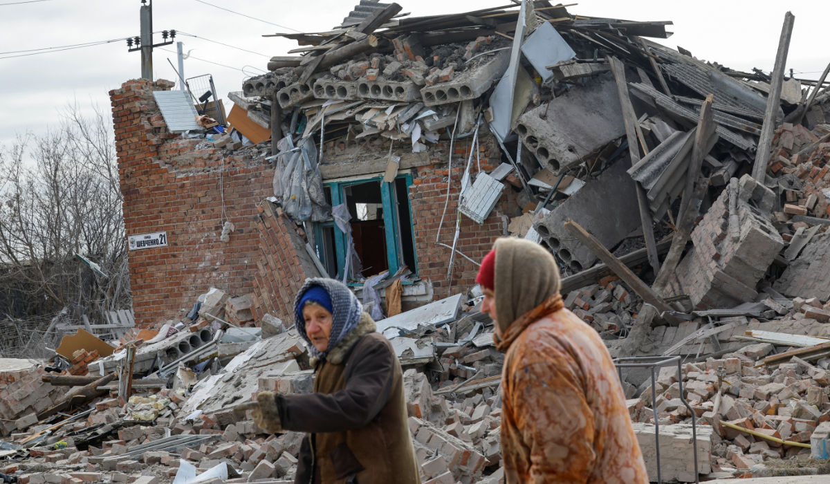 Local residents walk past a house destroyed by recent shelling in the course of Russia-Ukraine conflict in the settlement of Panteleimonivka in the Donetsk region, Russian-controlled Ukraine, February 17, 2024. (REUTERS)