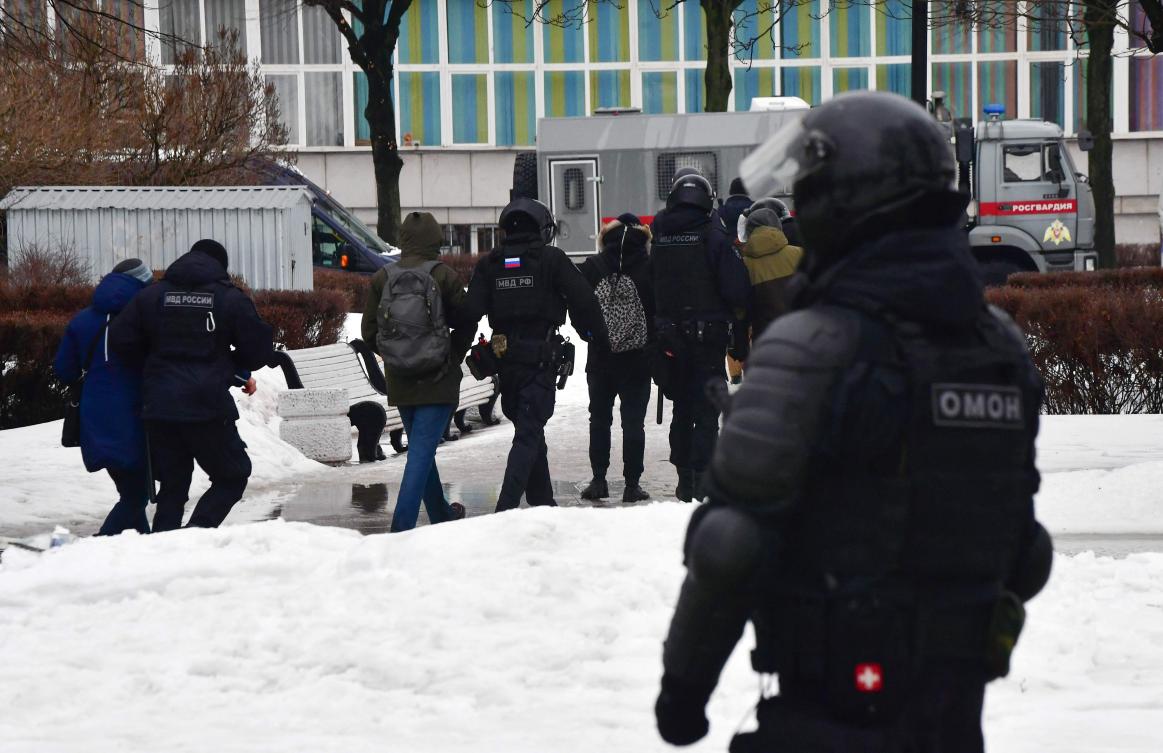 Riot police lead a group of people away from the monument to the victims of political repressions as people come to it to lay flowers for late Russian opposition leader Alexei Navalny in Saint Petersburg. (AFP)