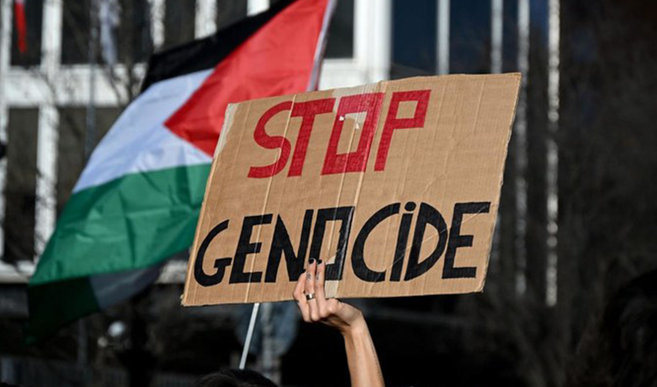 Demonstartors, one holding a placard and anothers the Palestinian flag during a 'Protest for Palestine' and in front of the Italian national television headquarter RAI, in central Rome on February 17, 2024. (AFP)