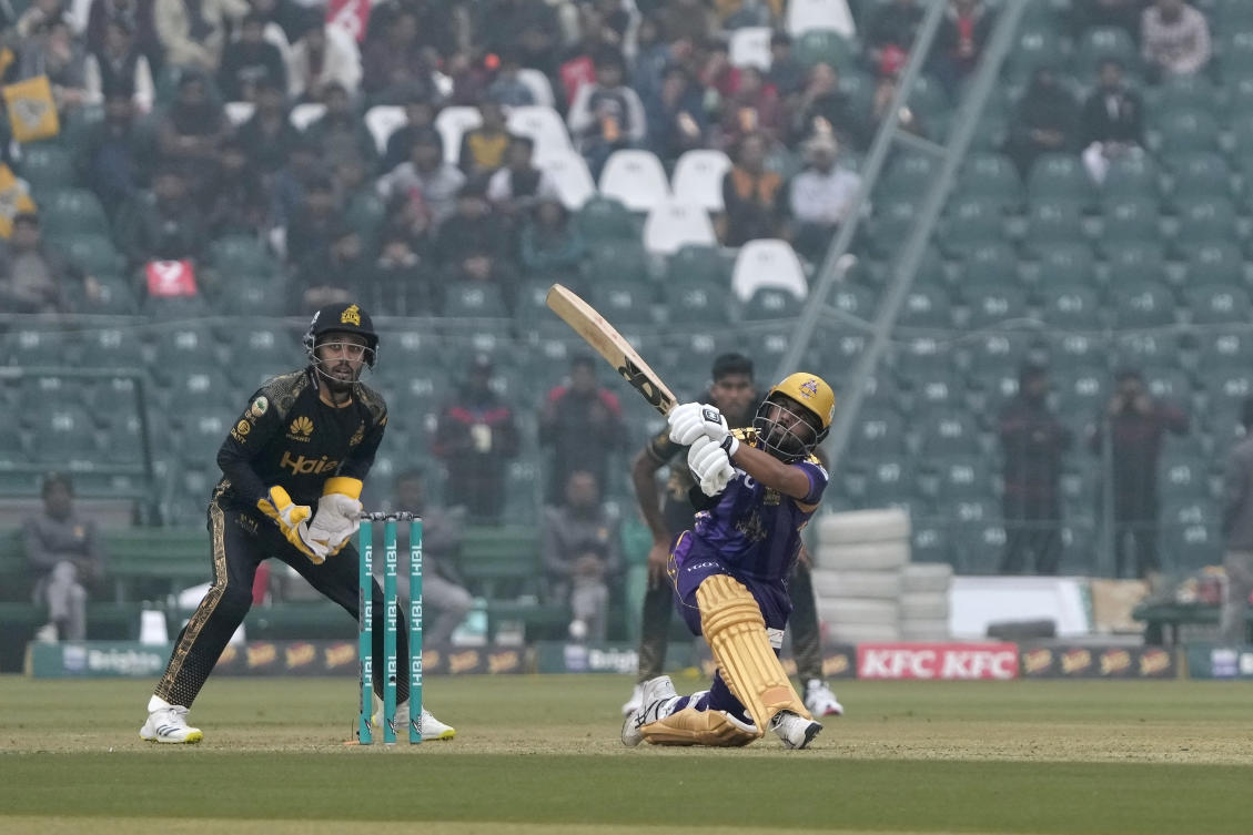 Quetta Gladiators' Saud Shakeel, right, plays a shot for six as Peshawar Zalmi' Mohammad Haris watches during the Pakistan Super League T20 cricket match. (AP)