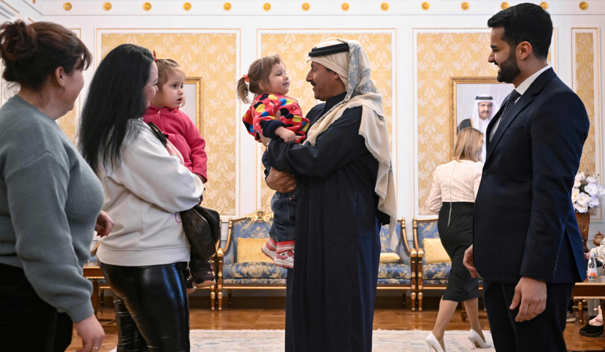 Ambassador of Qatar to Russia Sheikh Ahmed bin Nasser Al Thani and Russia's presidential commissioner for children's rights Maria Lvova-Belova (unseen) interact with Ukrainian children before their departure to Ukraine from Russia under a deal brokered by Qatar, at the Qatari embassy in Moscow on February 19, 2024. (AFP)