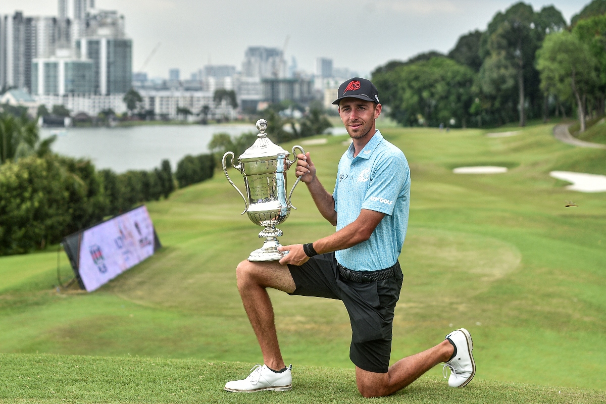 LIV player Spain's David Puig with the trophy after winning the Malaysian Open at the Mines Resort and Golf Club in Seri Kembangan on Feb. 18, 2024. Puig is in Oman this week, meaning four straight weeks of playing. (File/AFP)