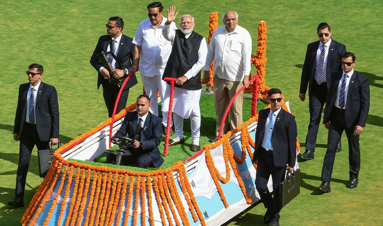 India's Prime Minister Narendra Modi (C) waves to the gathering at the golden jubilee celebration of Gujarat Co-Operative Milk Marketing Federation (GCMMF), owner of the flagship dairy brand Amul at the Narendra Modi Stadium in Ahmedabad on February 22, 2024. (AFP)