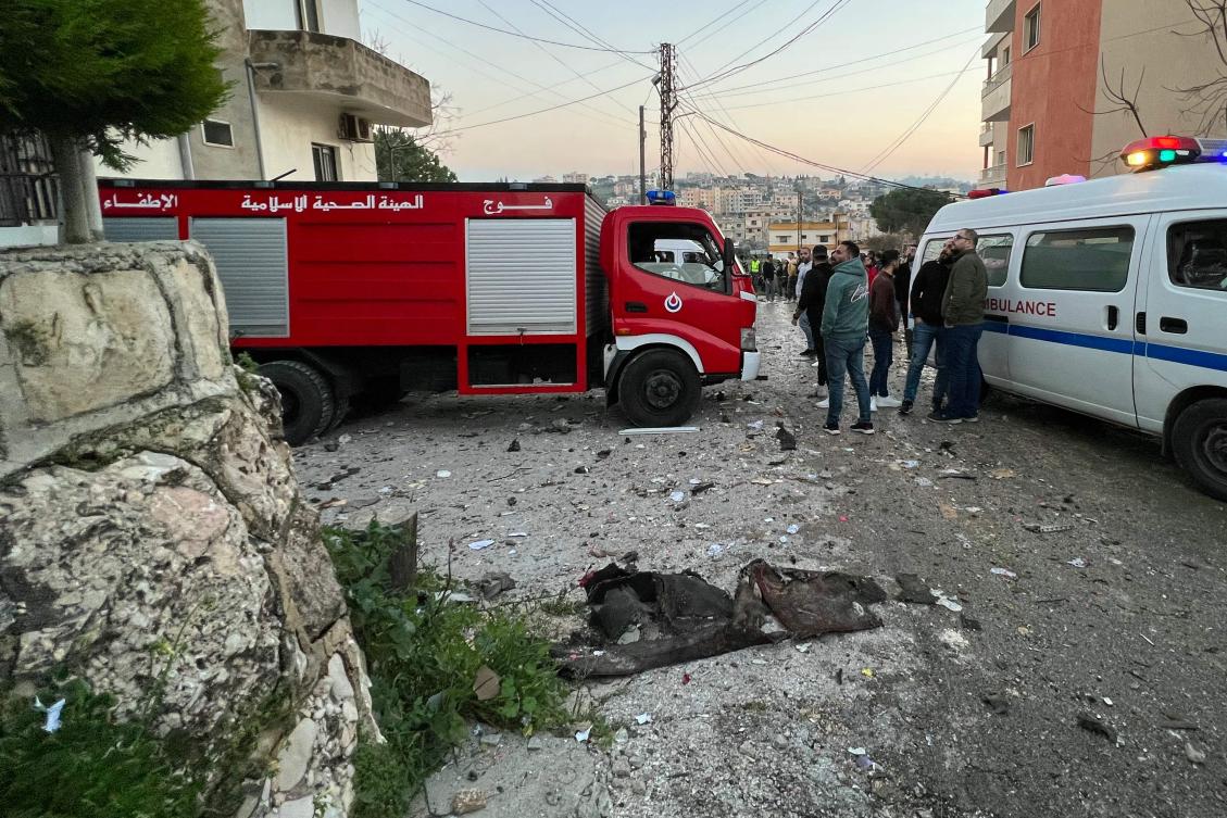 An ambulance and a fire engine rush to the scene where an Israeli drone shot two guided missiles at a building in Kfar Rumman near south Lebanon’s town of Nabatiyeh on Feb. 22, 2024. (AFP)