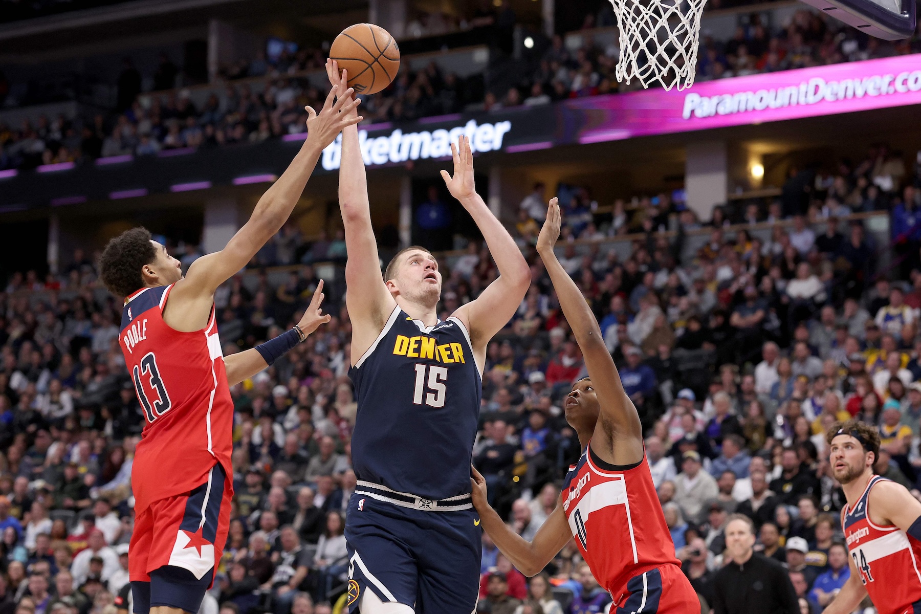 Nikola Jokic of the Denver Nuggets puts up a shot against Jordan Poole #13 and Bilal Coulibaly of the Washington Wizards in the fourth quarter of an NBA game at Ball Arena on Feb. 22, 2024 in Denver, Colorado. (AFP)