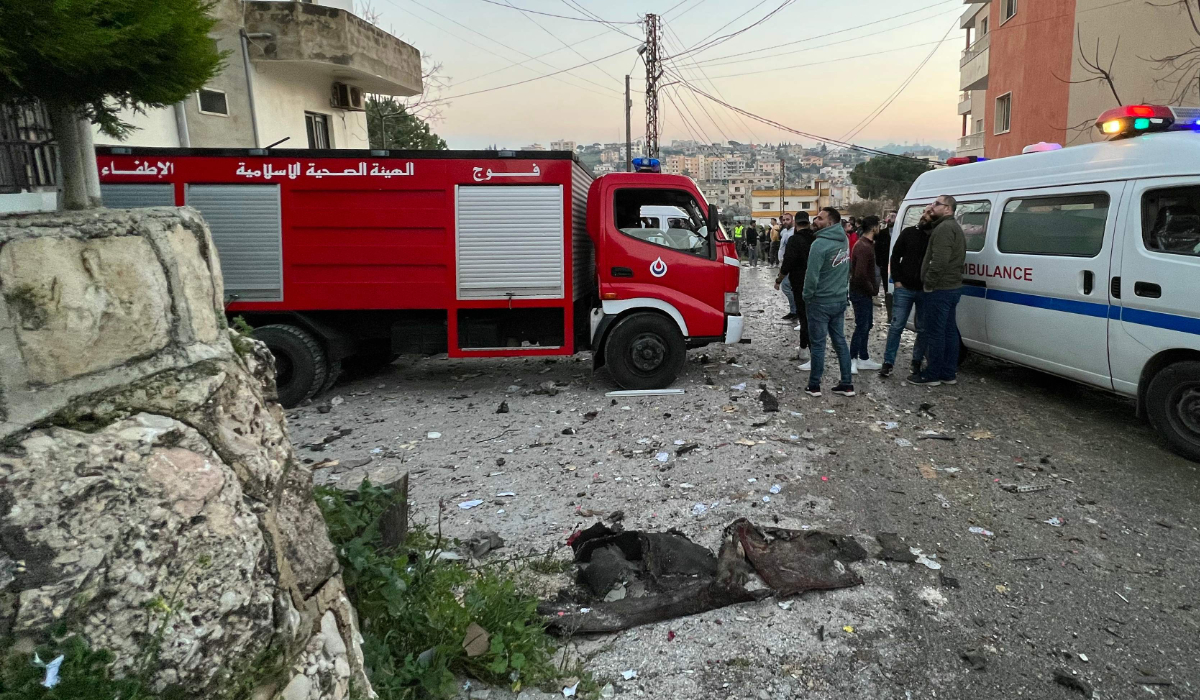 An ambulance and a fire engine rush to the scene where an Israeli drone shot two guided missiles at a building in Kfar Rumman near south Lebanon's town of Nabatiyeh on February 22, 2024. (AFP)