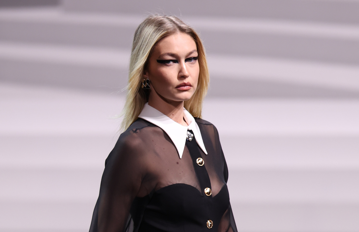 The supermodel stunned the runway in a black sheer, collared dress. (Getty Images)