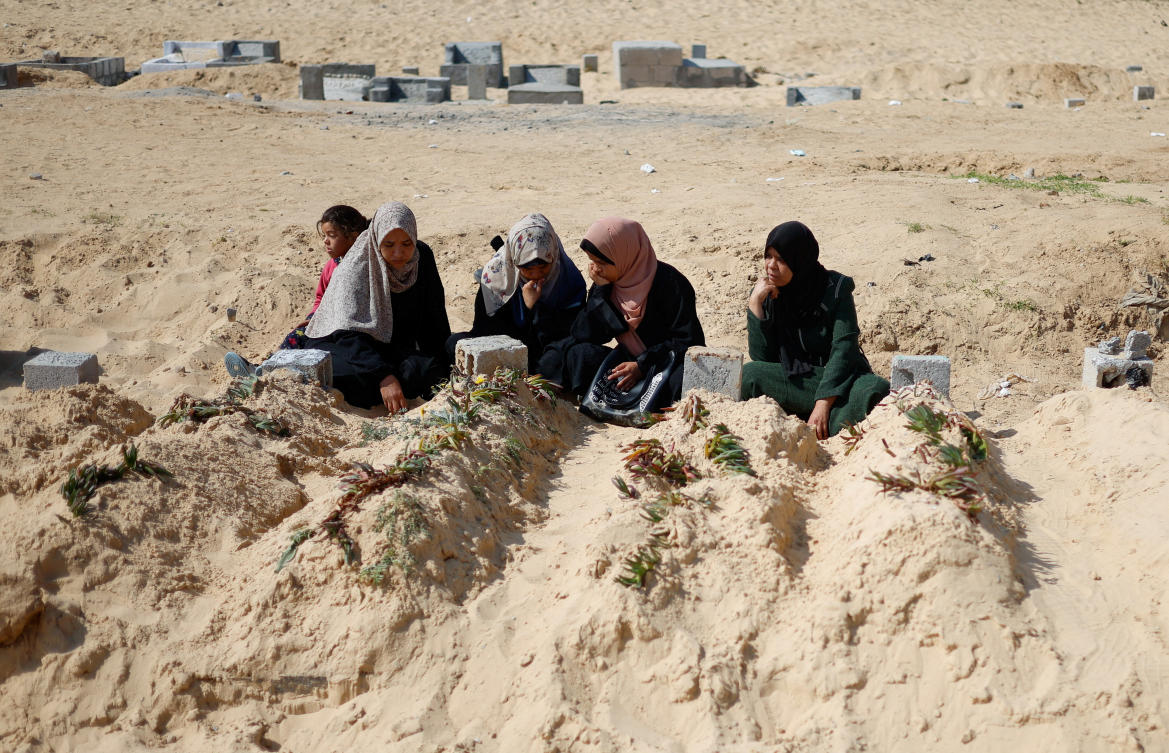 Palestinians visit a cemetery, amid the ongoing conflict between Israel and Hamas, in Rafah in the southern Gaza Strip, February 26, 2024. (Reuters)
