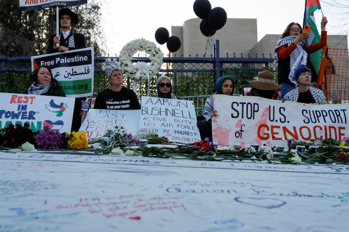 People participate in a memorial during a vigil for US Airman Aaron Bushnell, who died after setting himself on fire in front of the Israeli Embassy in Washington on Feb. 25 in an apparent act of protest against the war in Gaza, in Washington, on Feb. 26, 2024. (Reuters)