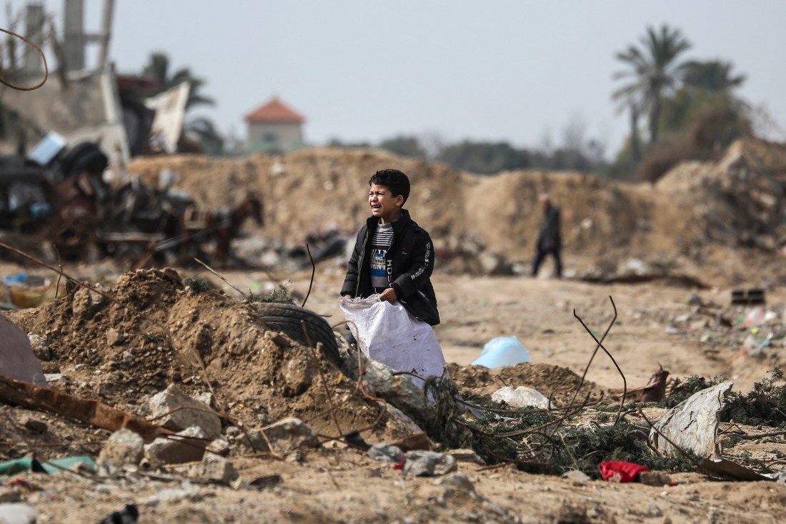 A Palestinian boy cries as he stands amid debris in the Maghazi camp. (AFP)