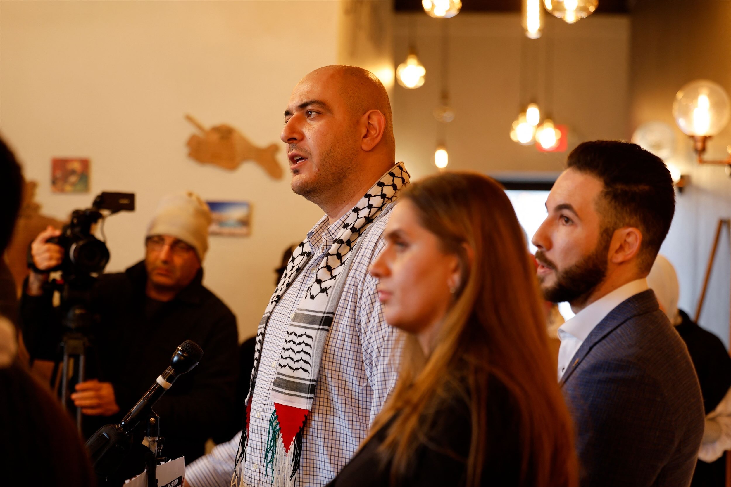 (L-R) Abbas Alawieh, spokesperson for Listen to Michigan, Layla Elabed, campaign manager for Listen to Michigan, and Dearborn Mayor Abdullah Hammoud speak to the press one day after the Michigan presidential primary, at Haraz Coffee House in Dearborn, Michigan. (AFP)