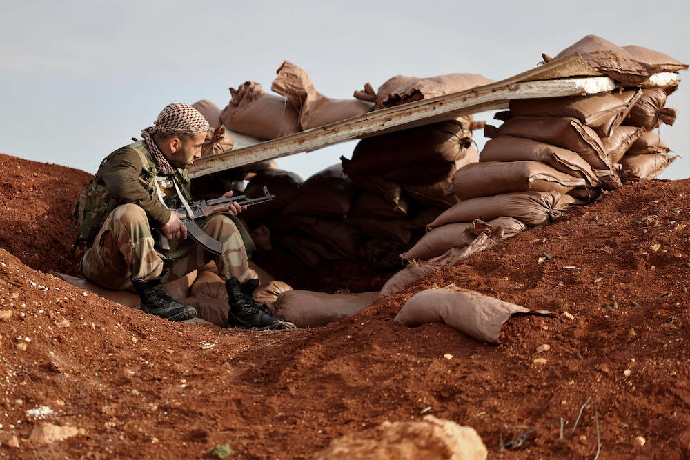 Syria’s war has killed more than 500,000 people and displaced millions since it erupted in 2011. Above, a Turkiye-supported Syrian fighter on the outskirts of the town of Marea, in the northern Aleppo countryside. (AFP)