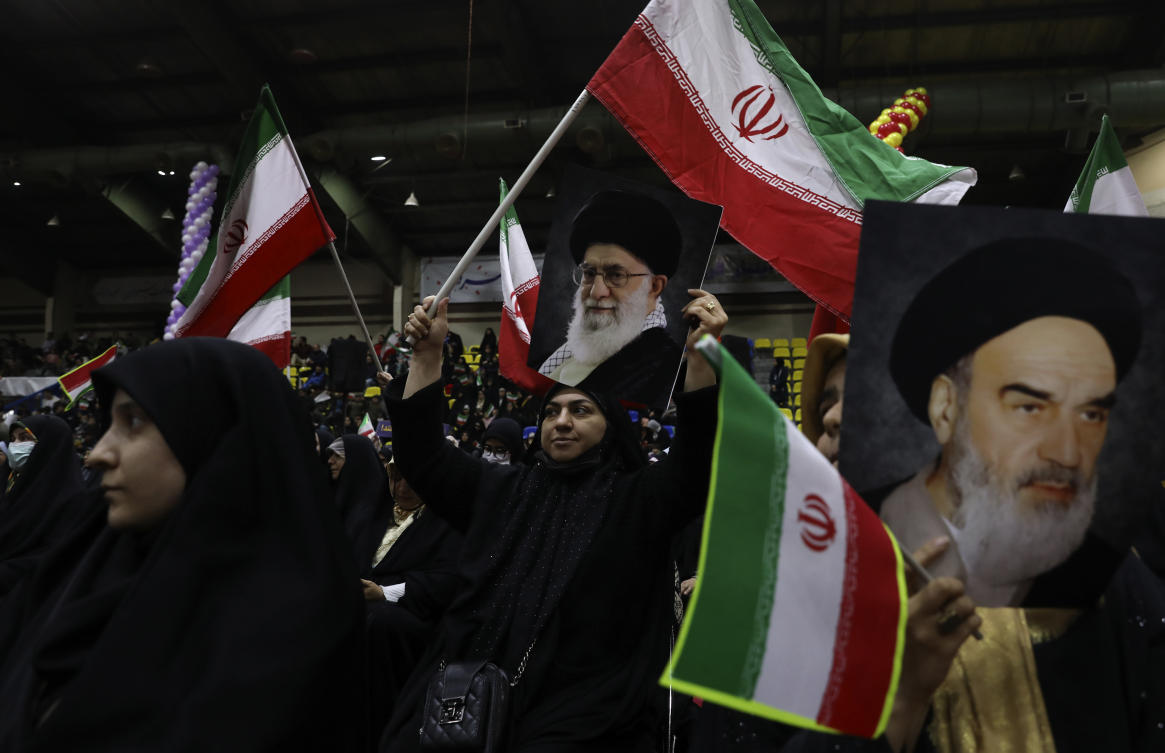 Iranian women wave their country’s flags as they hold posters of the Supreme Leader Ayatollah Ali Khamenei and the late revolutionary founder Ayatollah Khomeini during an election campaign rally ahead of Mar. 1, parliamentary and Assembly of Experts elections, in Tehran, on Feb. 27, 2024. (AP)
