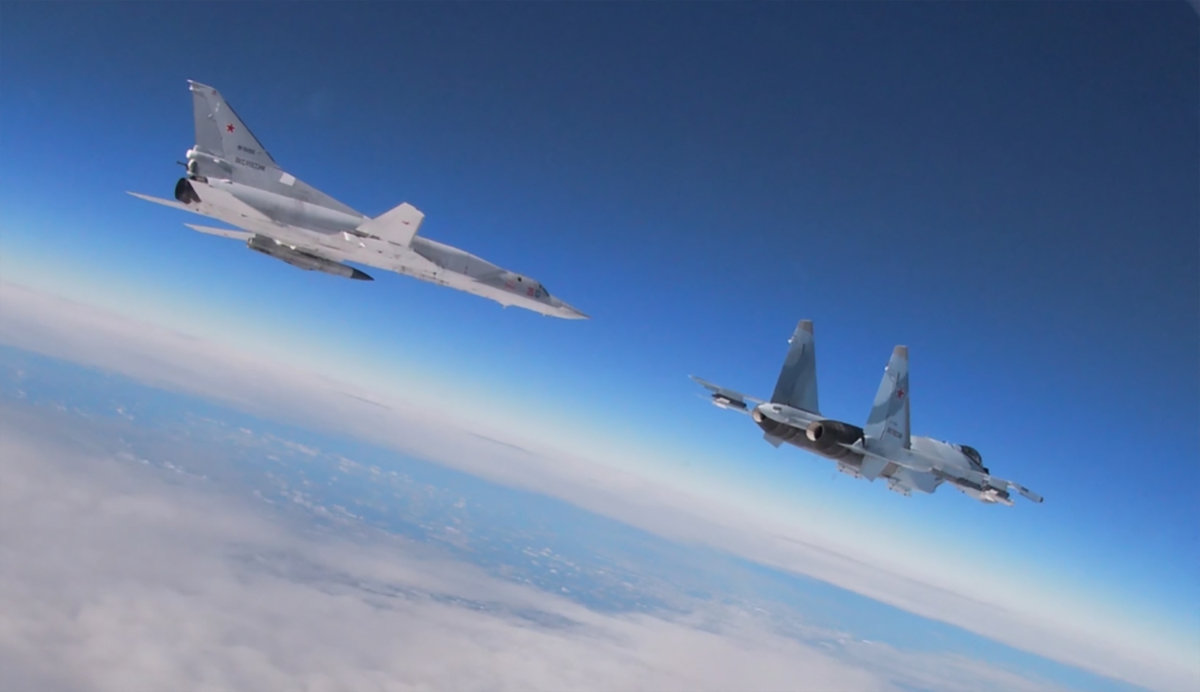An Su-35 multirole fighter (right) flies alongside a Tupolev Tu-22M3 Backfire strategic bomber during joint exercises of the armed forces of Russia and Belarus in 2022. (Russian Defense Ministry handout via AFP)